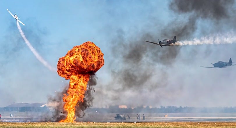 a plane is flying in the sky near a large explosion a plane is flying in the sky near a large explosion