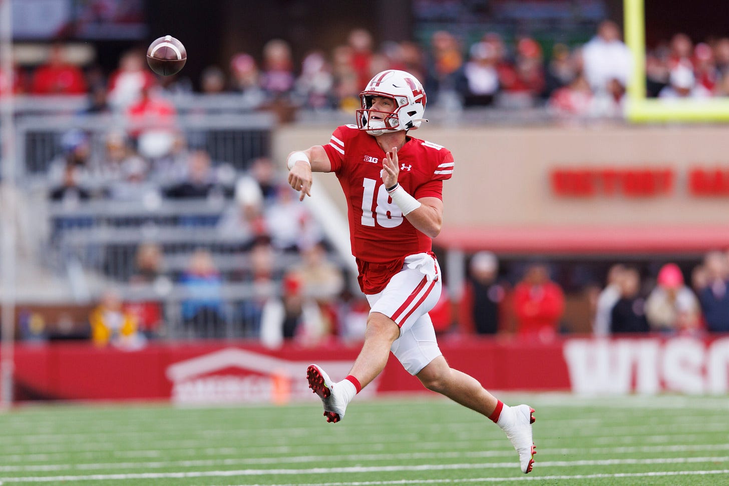 Wisconsin Badgers Football quarterback Braedyn Locke throws a pass against Iowa