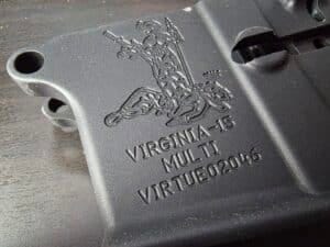 An AR-15 receiver with an engraving of the Virginia state seal An AR-15 receiver with an engraving of the Virginia state seal