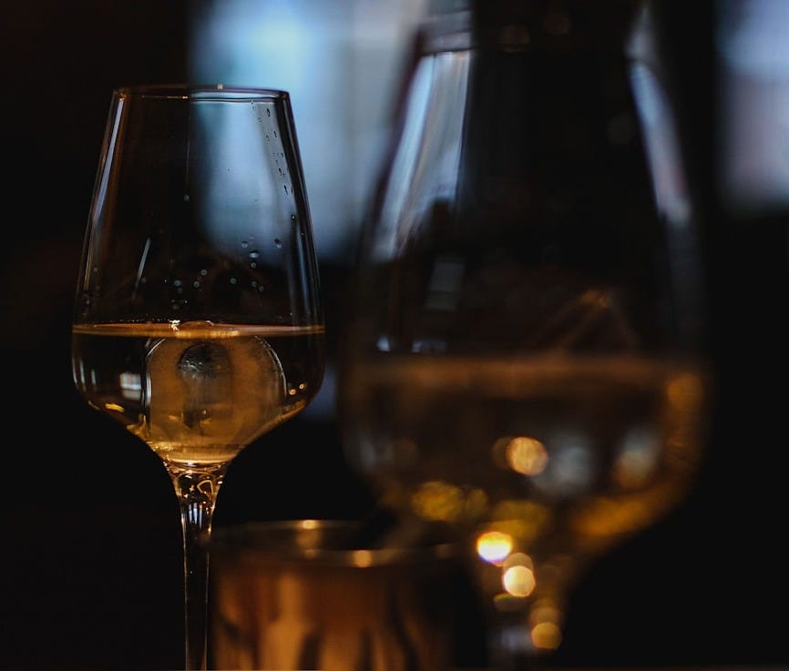 clear wine glass with brown liquid clear wine glass with brown liquid