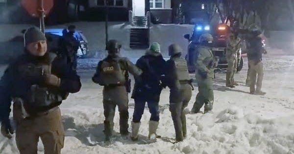 A person is detained by officers