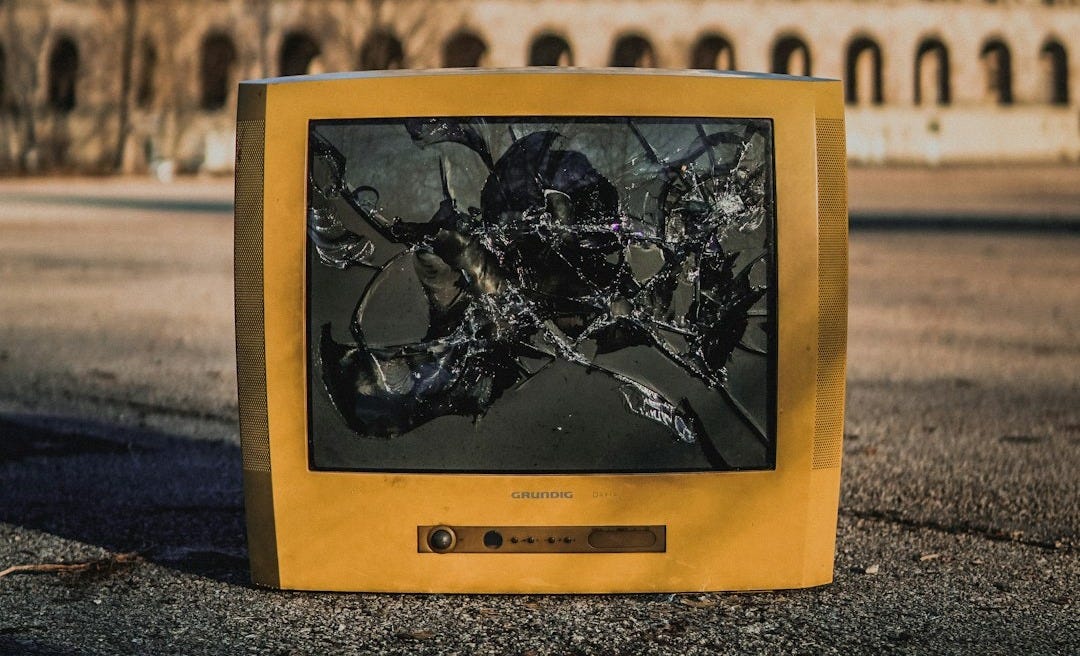 cracked beige monitor on the street