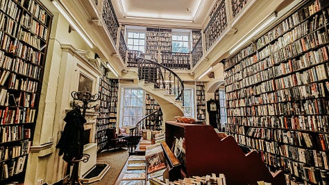 A collection of pictures of Bromley House Library, Nottingham, which has large bookshelves throughout