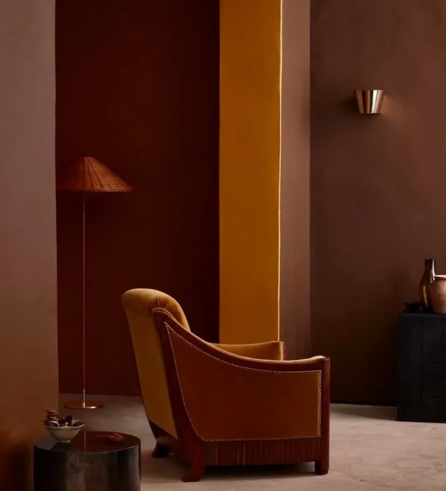 rich earthy hues of terracotta, clay and ochres with a chair positioned in the centre rich earthy hues of terracotta, clay and ochres with a chair positioned in the centre