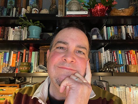 Jeffrey Keefer (at a Camino de Santiago sign in France, at my desk, and with a dolman on the Le Puy Camino)