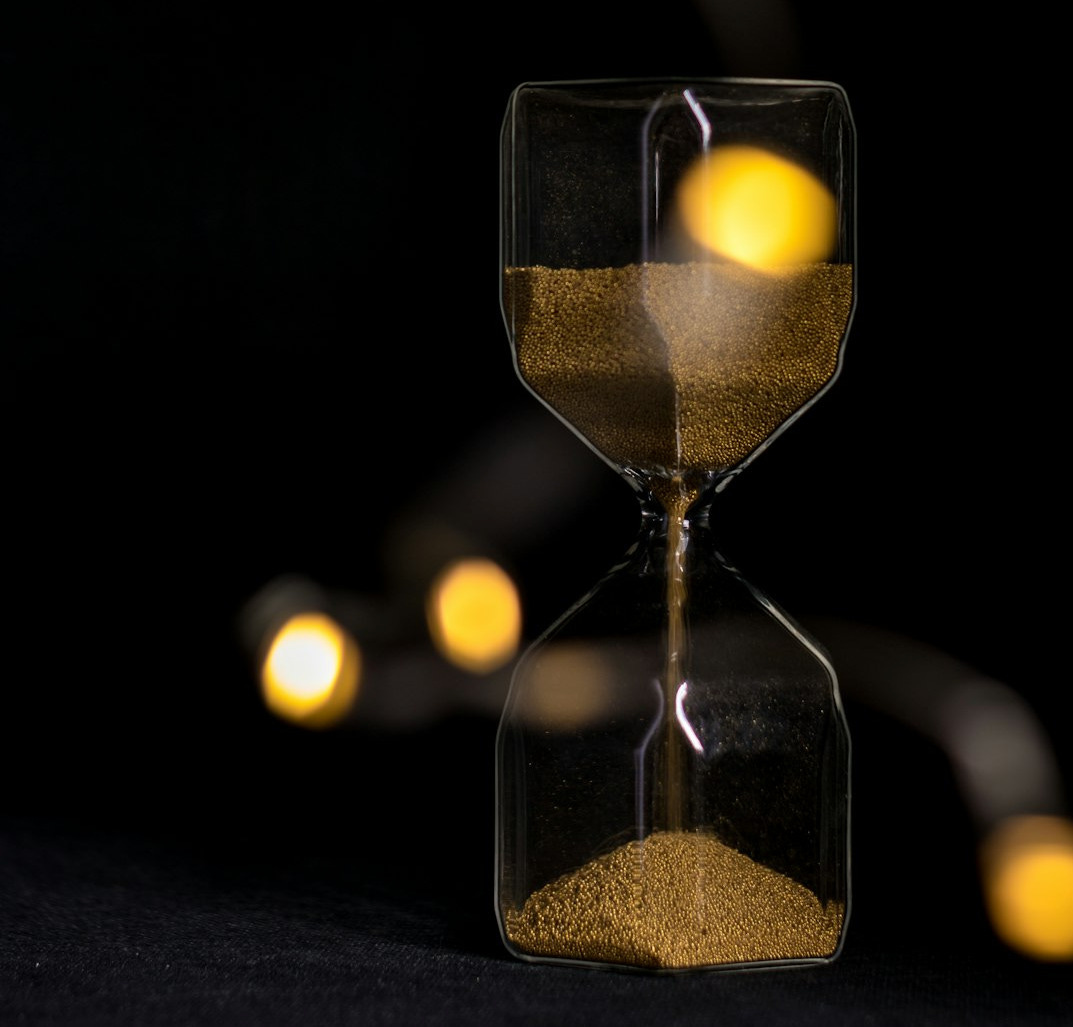 clear hour glass with yellow light clear hour glass with yellow light