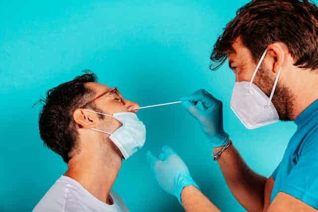 Man being swabbed by medic for COVID
