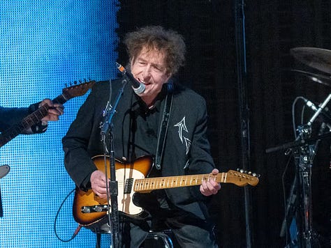 LEFT TO RIGHT: novelist Colson Whitehead (colsonwhitehead.com); rocket man Robert Goddard (kcentv); AI artist Brandon Carmody (brandoncarmody.com); PhD & RN Brittany Burch (University of Maryland); “death bed” (Daniel Troppy); Bob Dylan (Gary Miller/Getty)