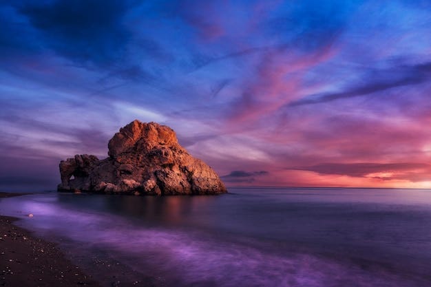 With the sun hidden the last lights illuminate the rock of the crow malaga spain
