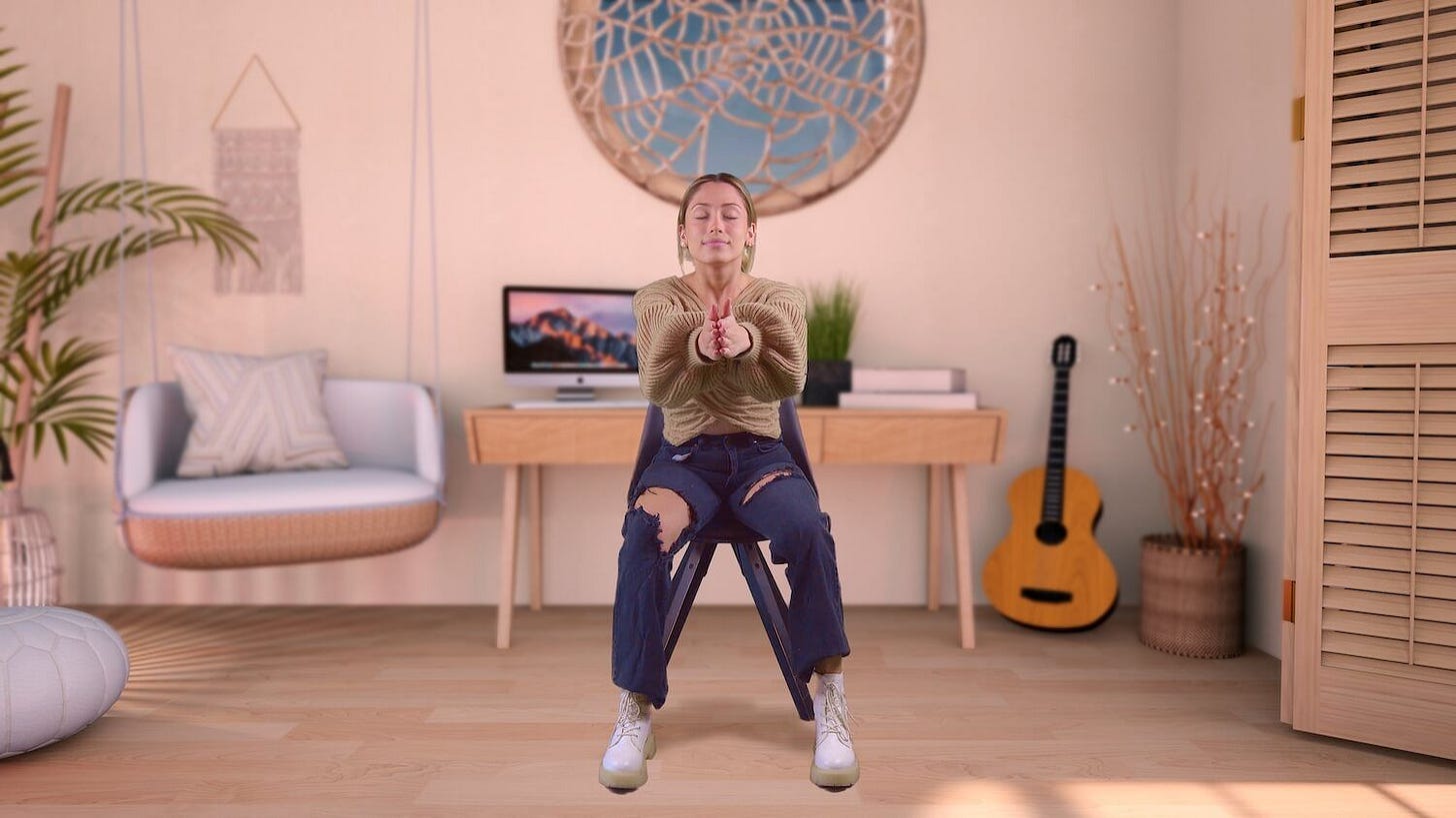 A young woman holding her palms together at home office