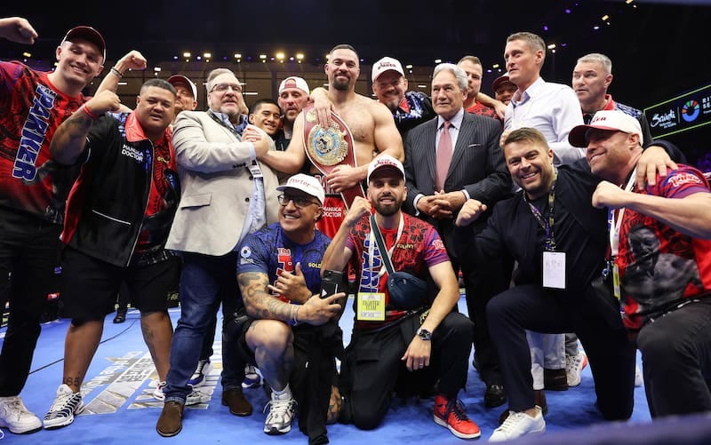 Joseph Parker celebrates in the ring with his team and supporters, including deputy Winston Peters, in Riyadh in 2025. 