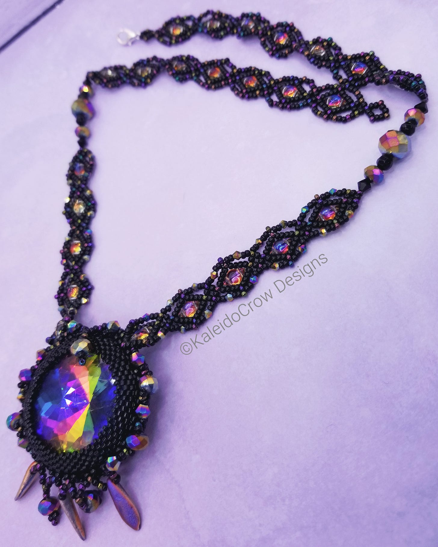 photos of a beaded necklace made with black and rainbow color shift/oil slick beads with a rainbow prism pendant