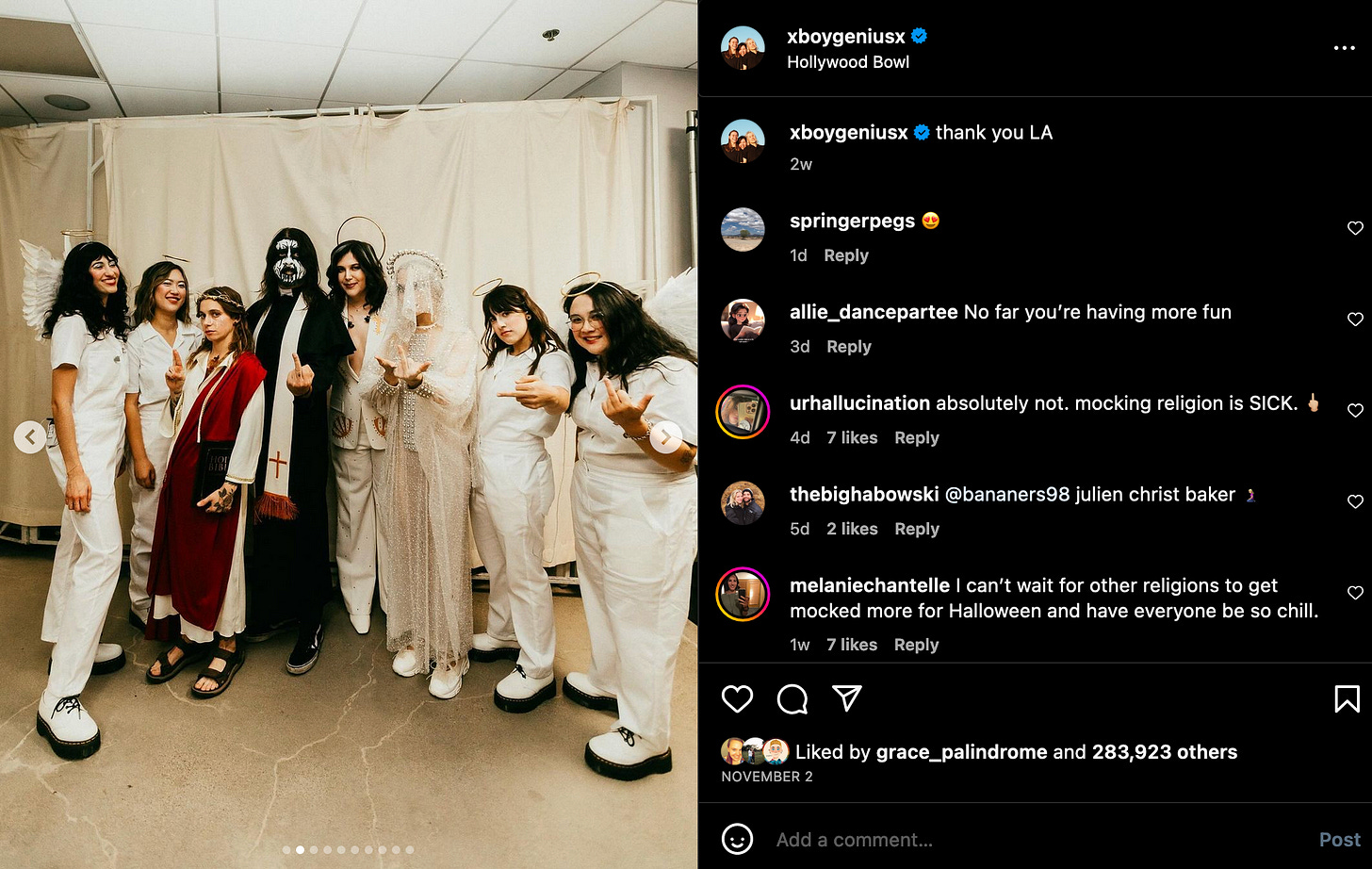 Screenshot of Instagram post by boygenius. The three members, David Grohl, and the backing band are posing together in costume. David Grohl is a haunted nun or priest and the backing band are angels. Most are giving middle fingers. Julien's hands are posed like Jesus' hands in iconography.