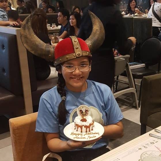 Me wearing a Viking helmet and holding a birthday cake