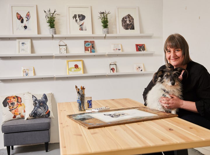 Photos of Jo Scott and her dog Thomasina with her dog art in her studio from 2018