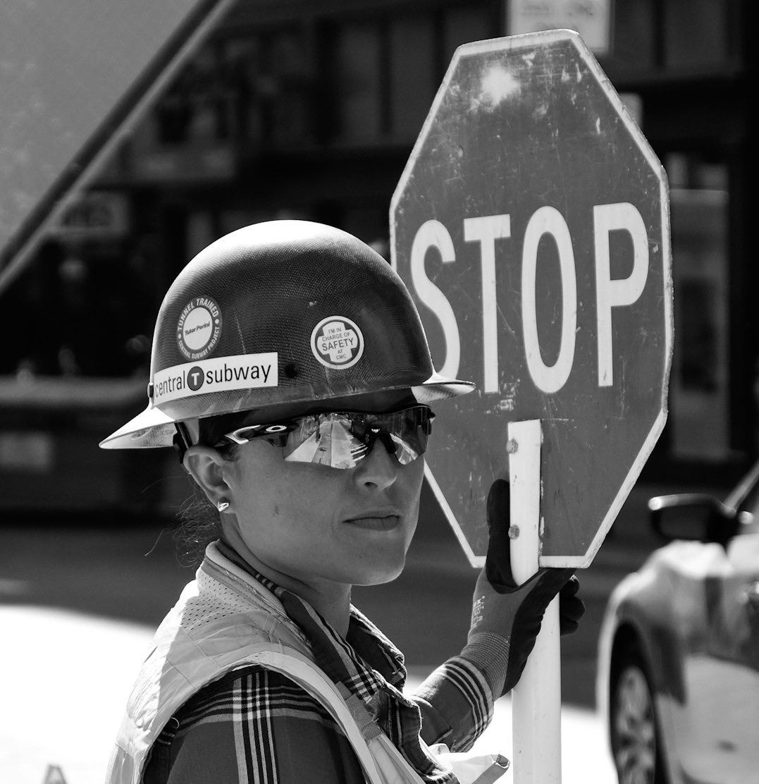 woman standing near the stop signage