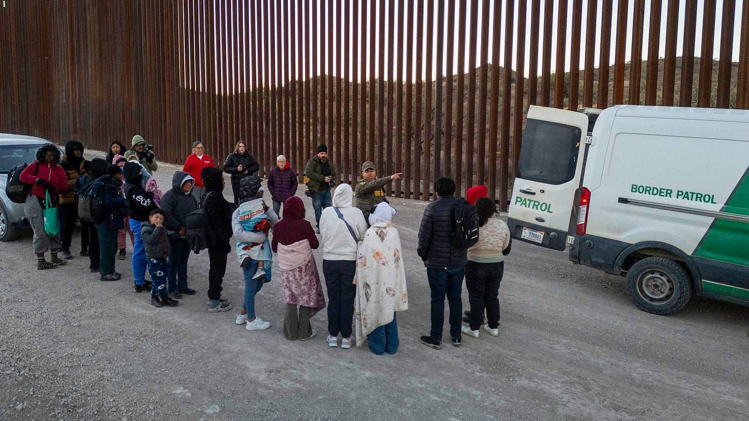 Immigrants wait to be transported by U.S. Border Patrol agents after crossing the U.S.-Mexico border on January 20, 2025 near Sasabe, Arizona.