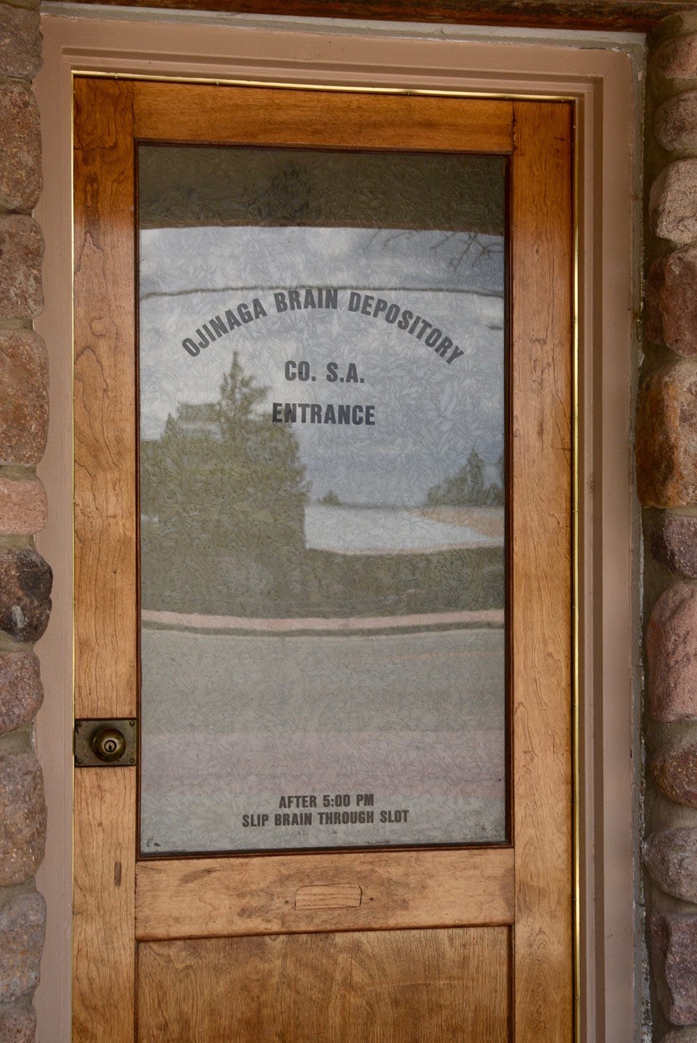 A glass door with a sign on it

Description automatically generated