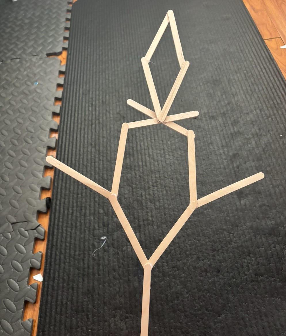 My son's "four-point shooter," built from leftover popsicle sticks. Nobody told him to make this. He just saw the supplies and started creating. My son's "four-point shooter," built from leftover popsicle sticks. Nobody told him to make this. He just saw the supplies and started creating.