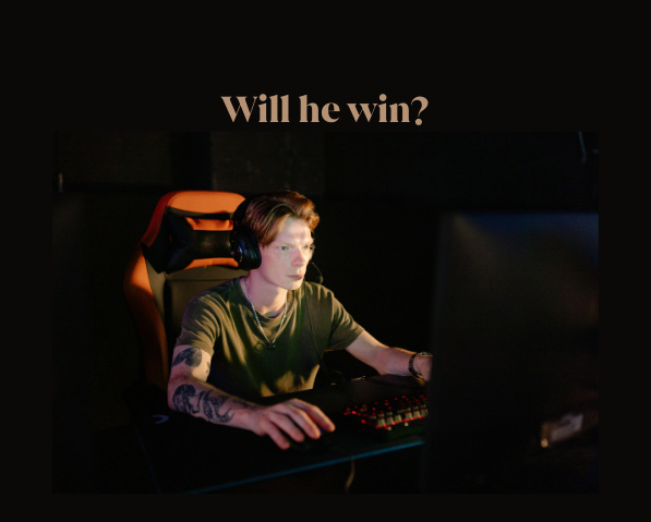 boy playing computer game in dark room