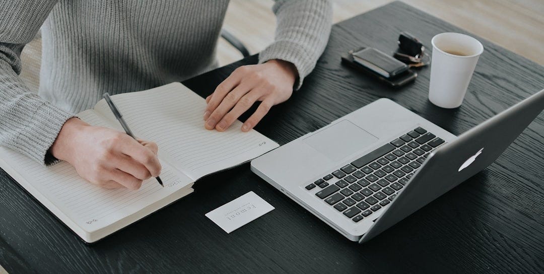 person in white dress shirt holding white paper