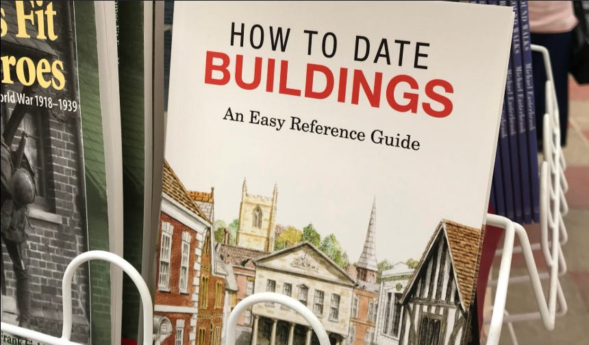 A book on a shop rack titled How to Date Buildings, an easy reference guide