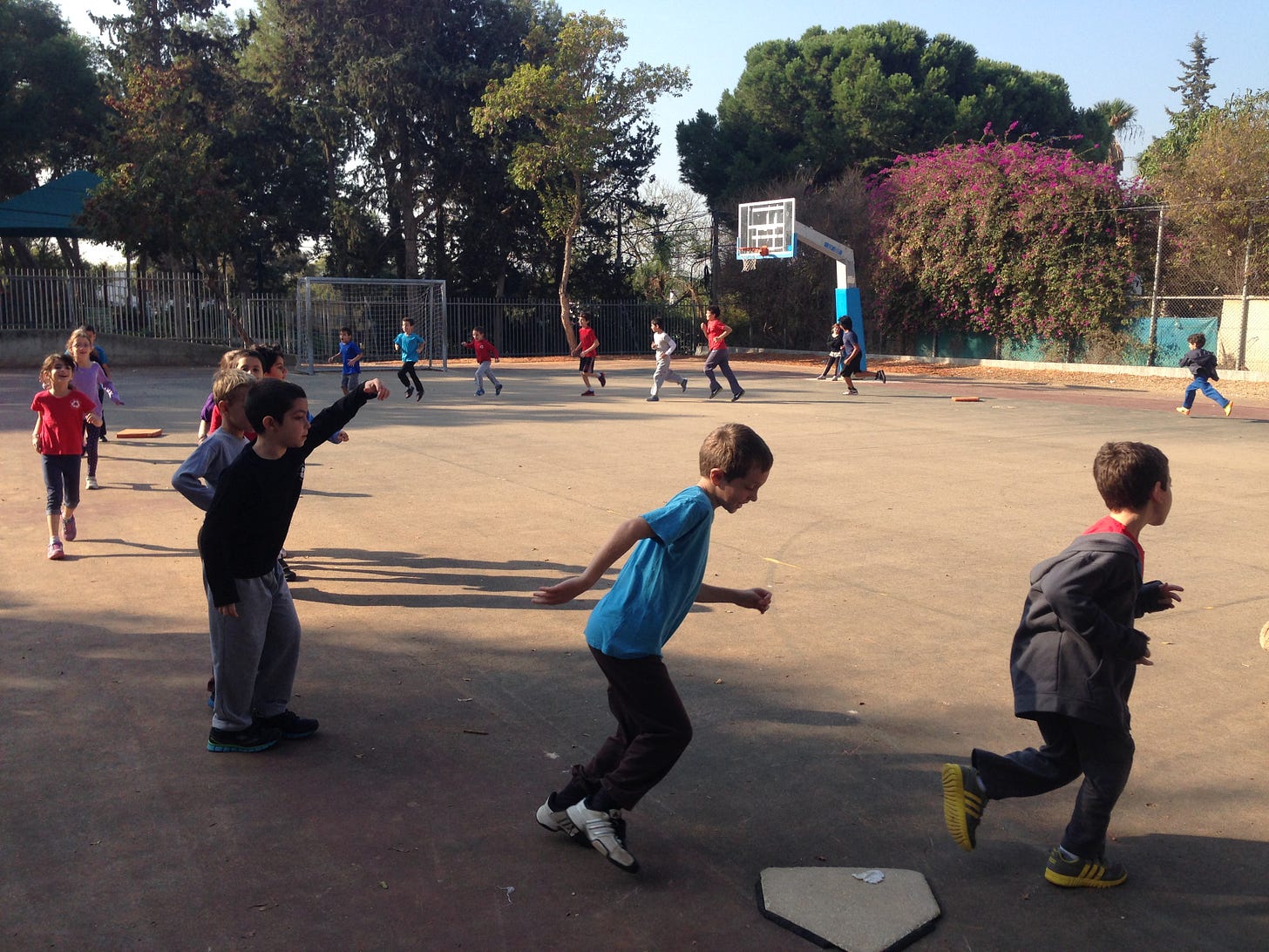 The kids running bases to warm up.