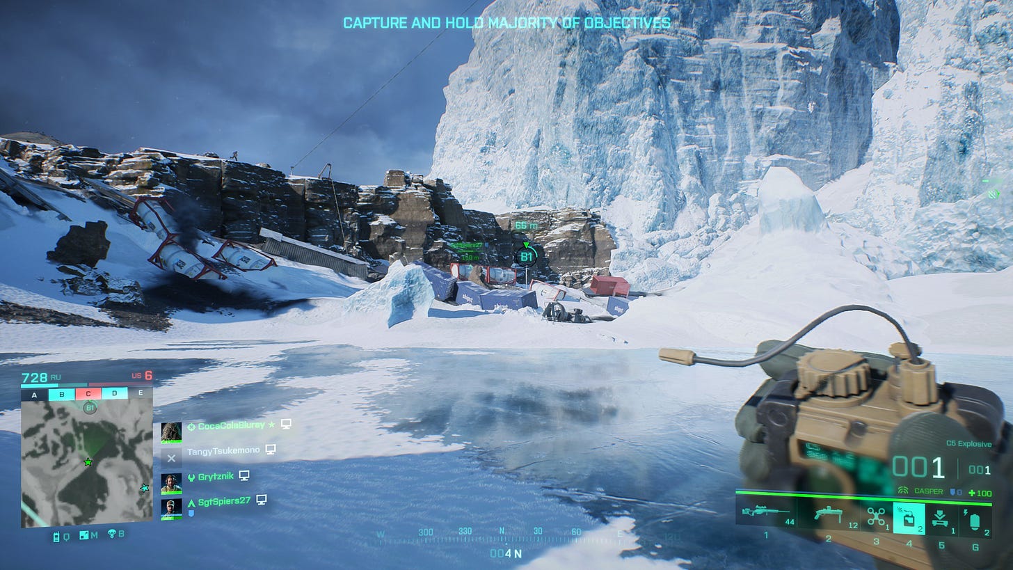 the player holds C4 in their hand as they approach a flag in a snowy, Antarctic map.