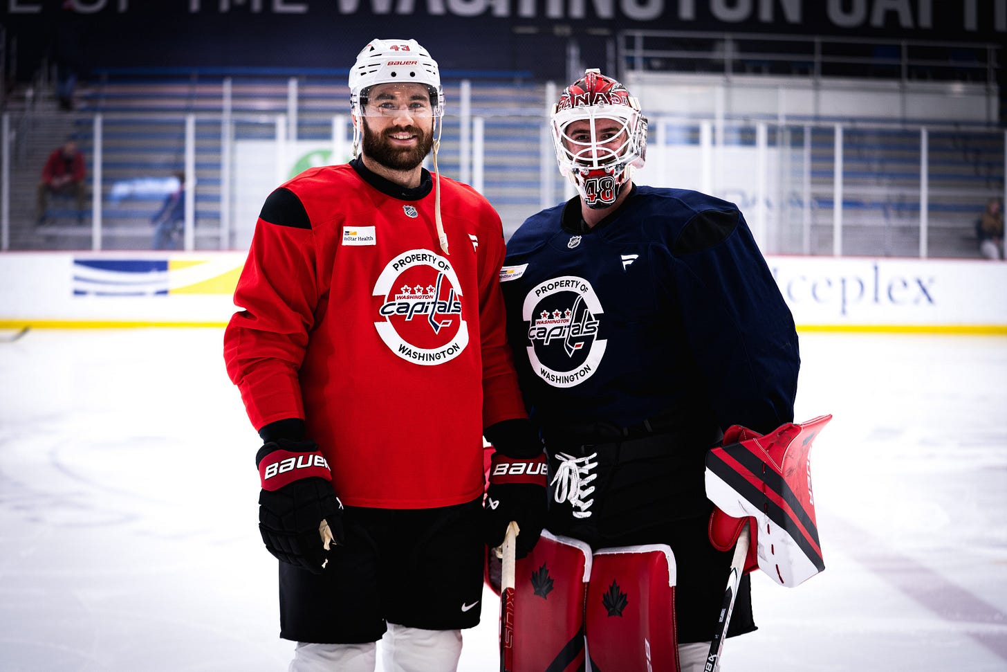 Tom Wilson and Logan Thompson pose for a photo at MedStar Capitals Iceplex. 