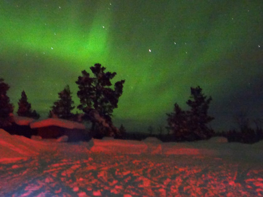The green bit is the northern lights, the red bit is the brake lights.