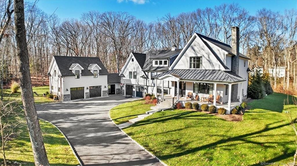 a front view of a house with a yard table and chairs a front view of a house with a yard table and chairs