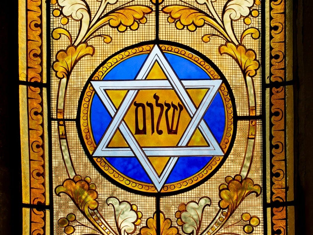 a stained glass window with a star of david on it