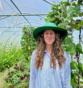 Portrait photo of Sarah McFadden in a greenhouse