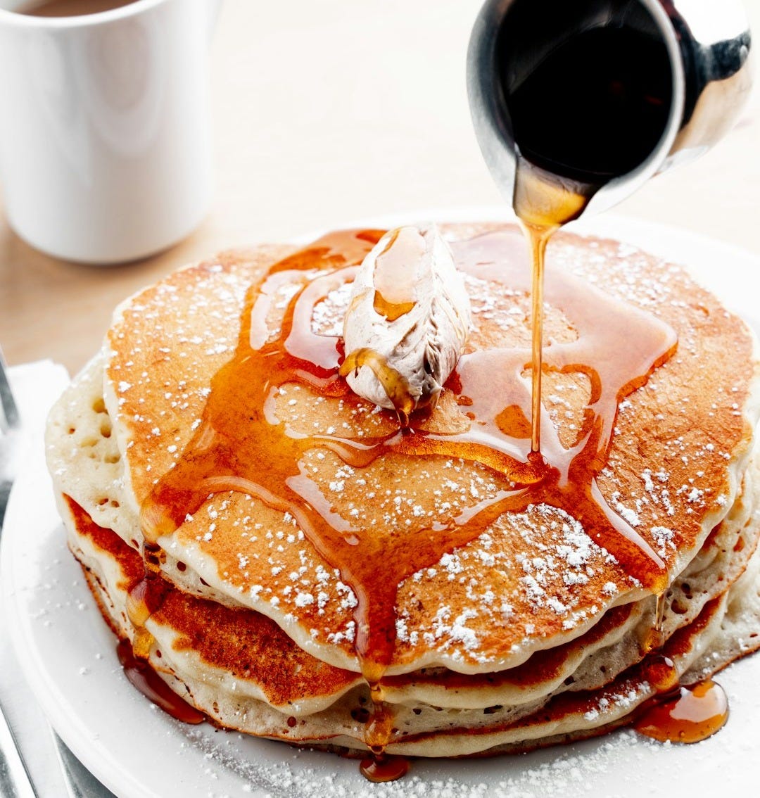 Maple syrup drizzled on a stack of pancakes Maple syrup drizzled on a stack of pancakes