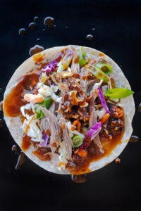 Peking-inspired Sonoran-style roast goose tacos with shredded cabbage, carrots, Salsa Macha and hoisin sauce. Food photography and recipe by Jackie Alpers.