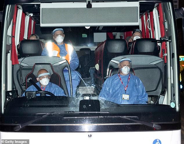 The bus carrying the British passengers and crew being repatriated from the MV Hondius makes its way to Arrowe Park Hospital on May 10, in Birkenhead, England