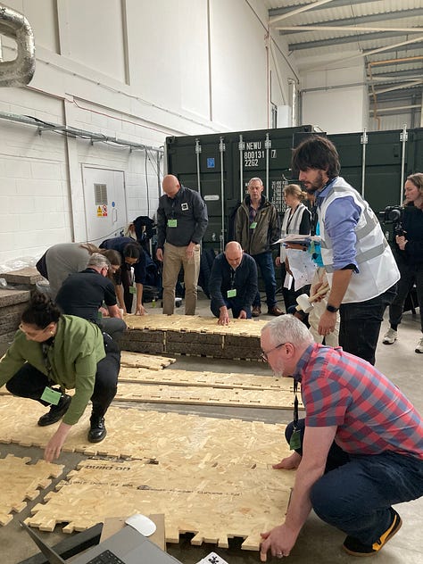 Images showing the BE-ST Fest conference attendees and a series of images of a WikiHouse build. People can be seen building and insulating WikiHouse blocks and connecting them together.