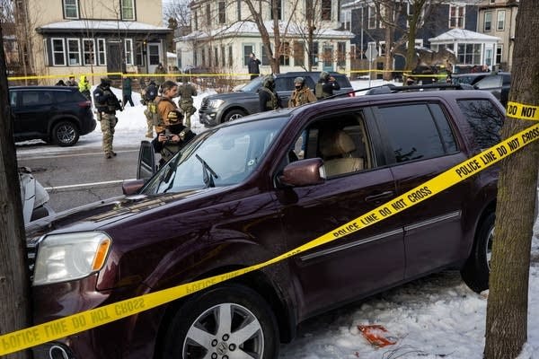 Agents surround a crashed car