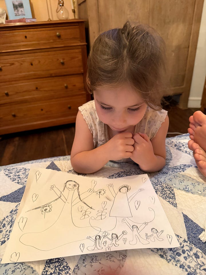 Two children reading in bed under a quilt, and a young girl lying on a bed looking at a drawing of figures with hearts and flowers.