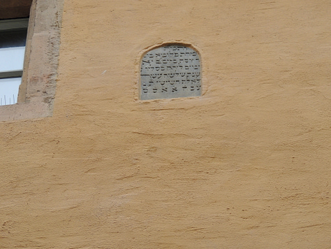 photos of buildings, a cathedral. a plaque, and a gravestone embedded in a wall