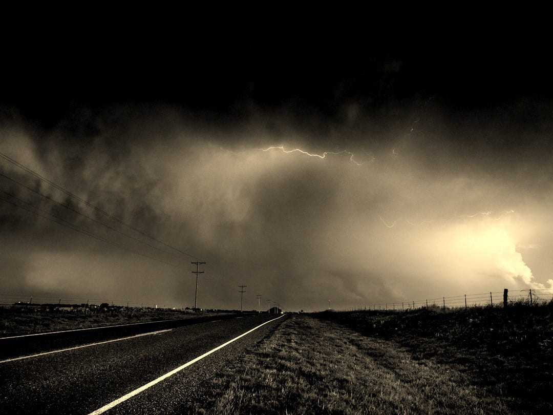 gray concrete road under gray clouds