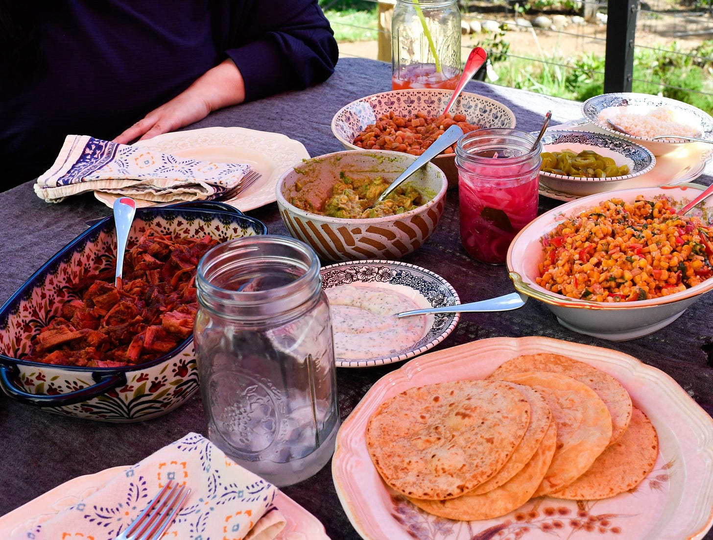mexican food spread out on a table outdoors