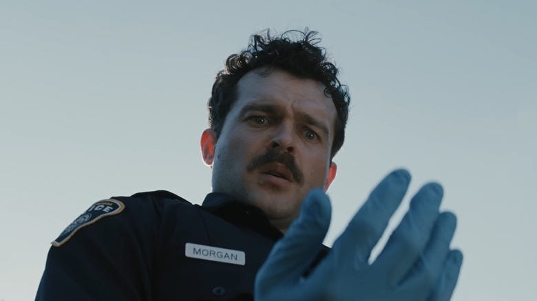 Alden Ehrenreich as Paul looking with fear at his hand in Weapons Alden Ehrenreich as Paul looking with fear at his hand in Weapons