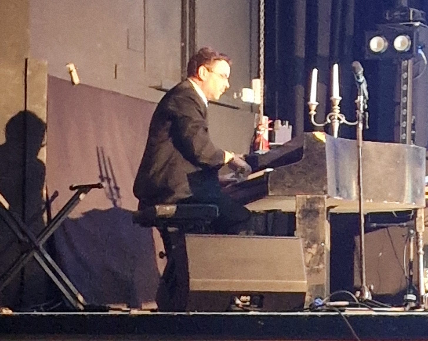 Man on stage playing piano.