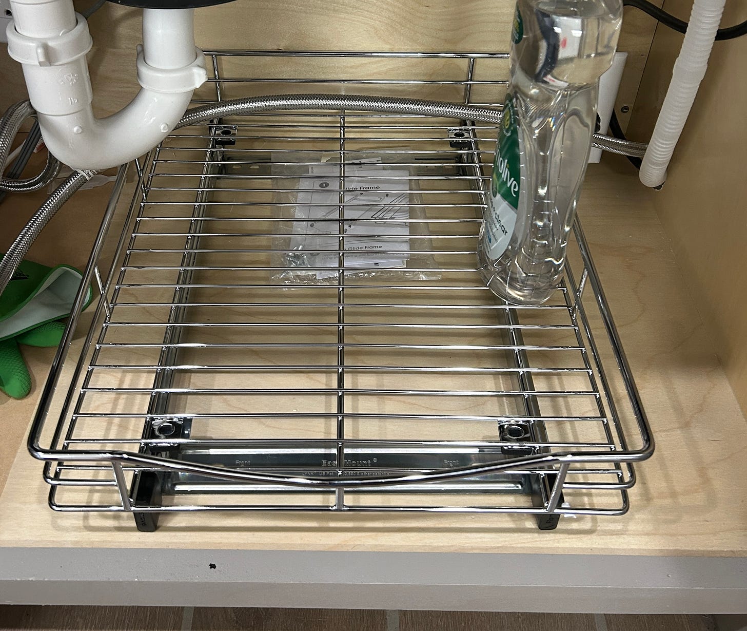 Metal pull out drawer under sink.