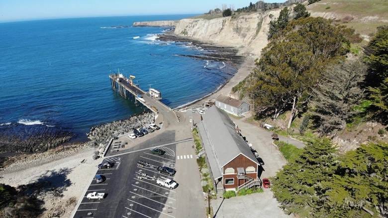 A parking lot next to a body of water

AI-generated content may be incorrect.