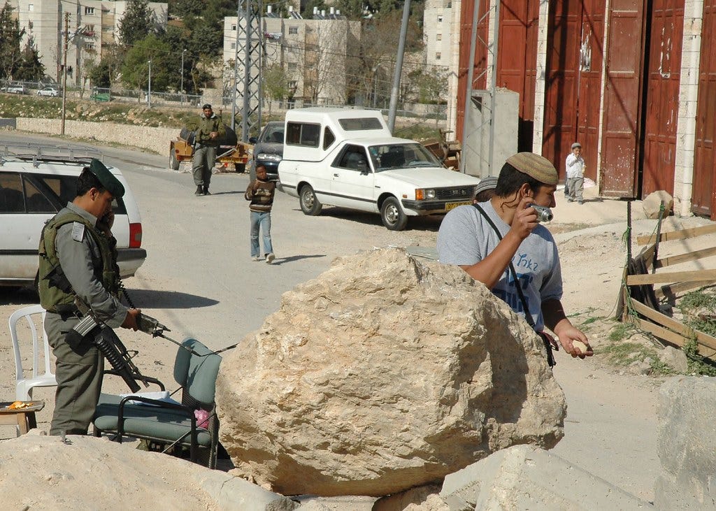 Israeli settlers and guards in Hebron Israeli settlers and guards in Hebron