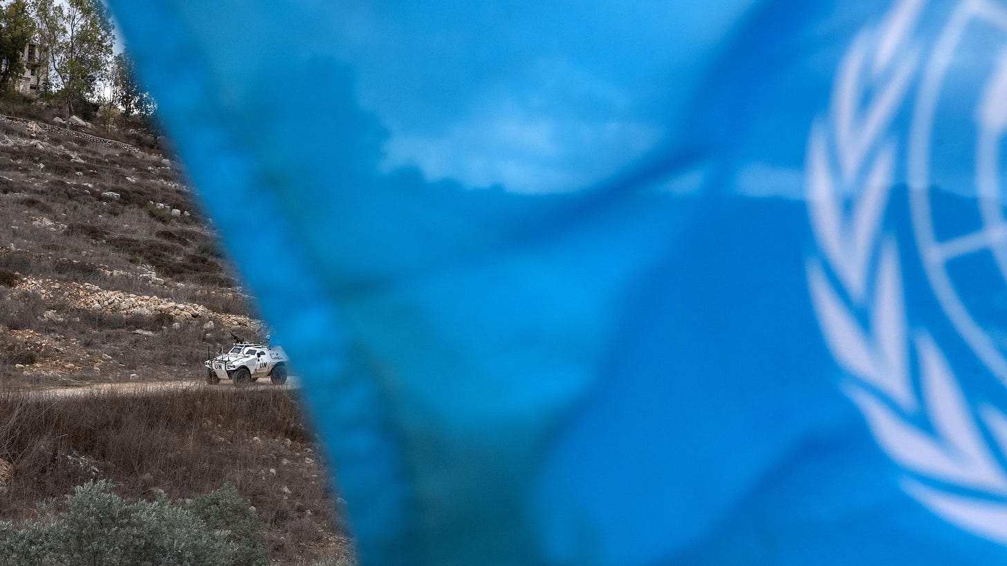 UNIFIL armored vehicles with UN markings positioned in southern Lebanon, with military equipment visible in a conflict-affected area
