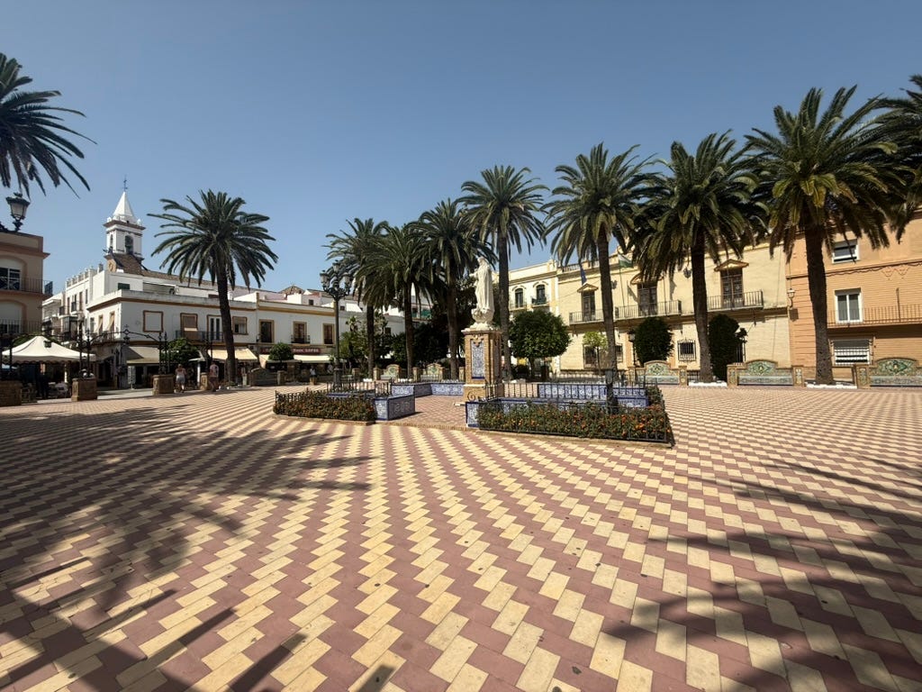 A plaza with palm trees in Ayamonte