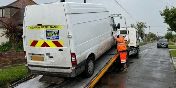 White van on a transporter lorry